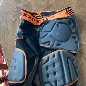 Boys medium football skockskin 5 pad extended thigh impact shorts.